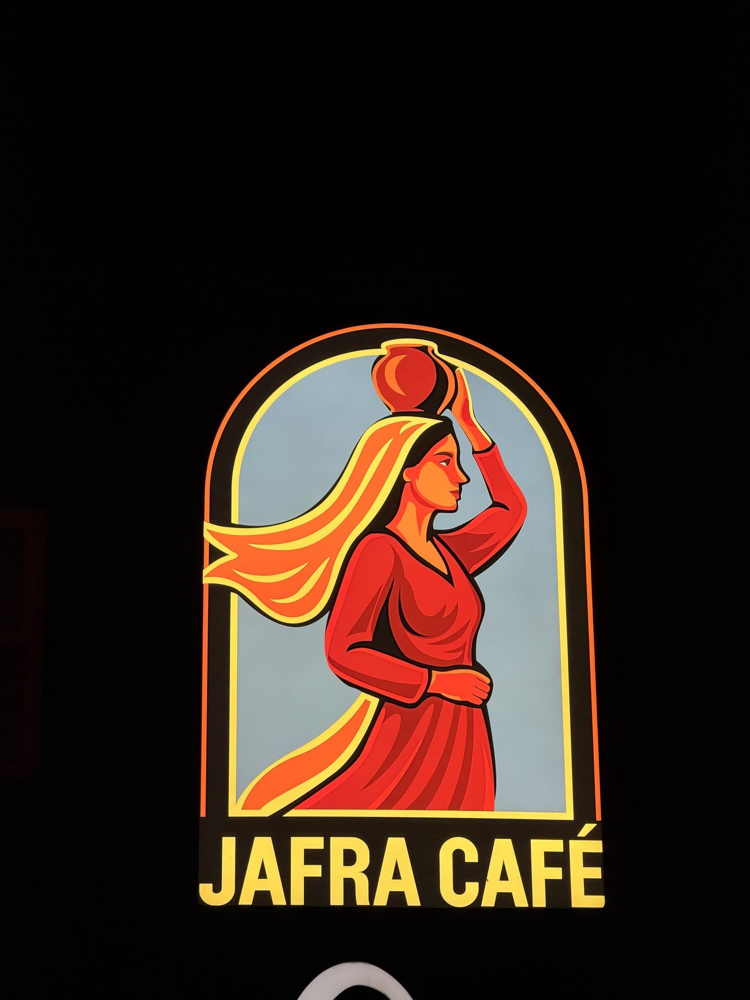 The illuminated Jafra Café sign on Hampshire Street at night